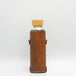 Leather water bottle holder with strap and glass bottle